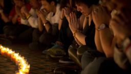 Relatives of Chinese passengers onboard Malaysia Airlines Flight 370 pray during a candlelight vigil for their loved ones at a hotel in Beijing, China, Tuesday, April 8, 2014.
