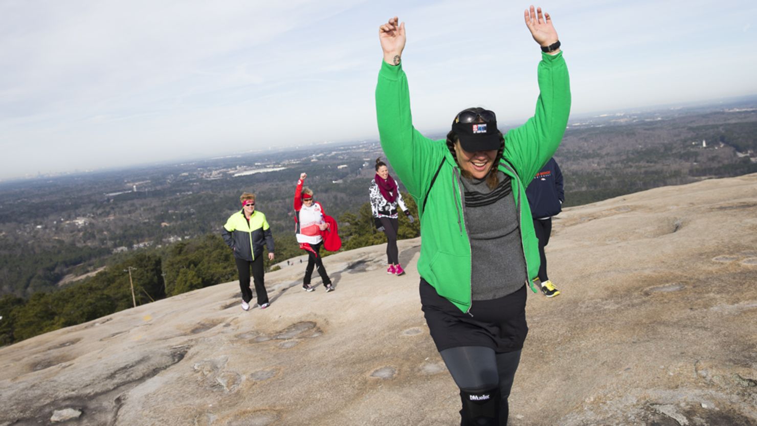 Sia Figiel reaches the top of Stone Mountain during the Fit Nation kickoff weekend in Atlanta. 