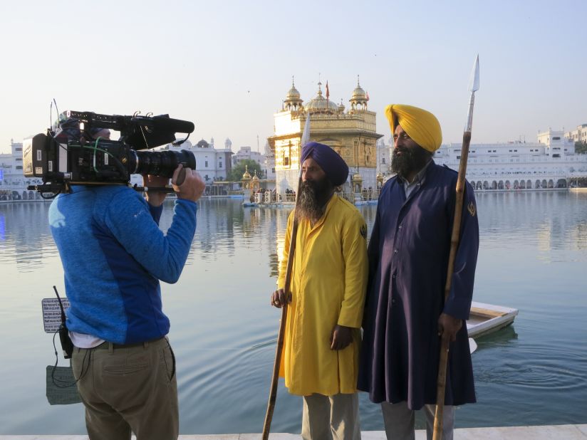Two men are filmed outside the Golden Temple, a central place of worship for Sikhs in Amritsar, India. 
