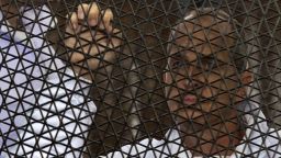 Australian journalist Peter Greste of Al-Jazeera looks on standing inside the defendants cage during his trial for allegedly supporting the Muslim Brotherhood at Cairo's Tora prison on March 5, 2014. The high-profile case that sparked a global outcry over muzzling of the press is seen as a test of the military-installed government's tolerance of independent media, with activists fearing a return to autocracy three years after the Arab Spring uprising that toppled Hosni Mubarak. AFP PHOTO / KHALED DESOUKI (Photo credit should read KHALED DESOUKI/AFP/Getty Images)