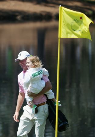 Brandt Snedeker of the United States walks with his daughter Lily around the Augusta course.