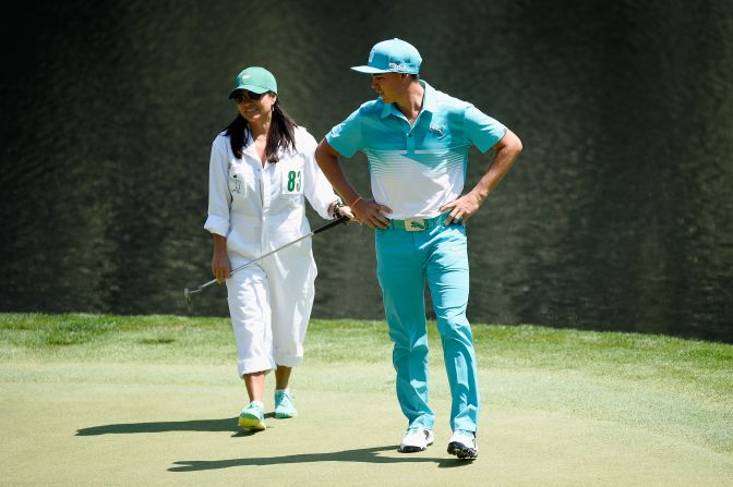 Rickie Fowler of the United States waits with his mom Lynn on the ninth green during the Par 3 Contest.