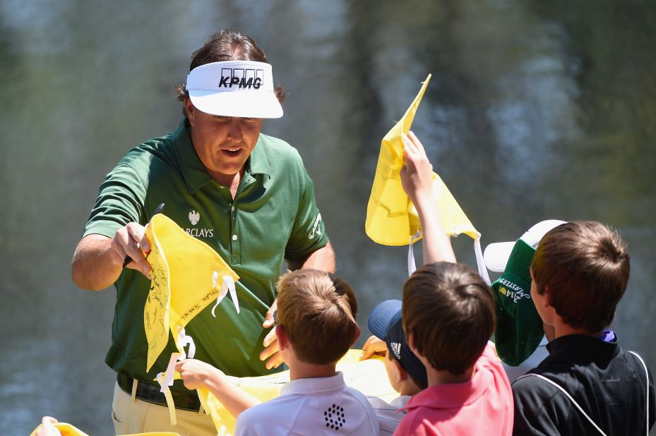Phil Mickelson, a three-time winner at Augusta, signs autographs ahead of the Par 3 Contest.