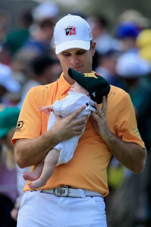 Kevin Streelman holds his baby girl, Sophie, before sampling the greens of Augusta.