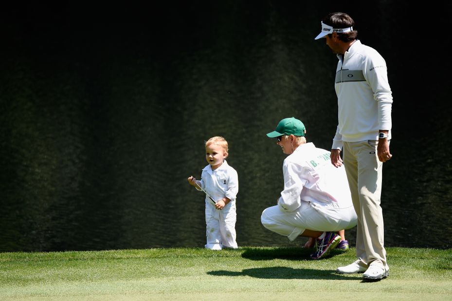 Bubba and Angie Watson wait with their son Caleb on the ninth green. Watson won the Augusta Masters in 2012.