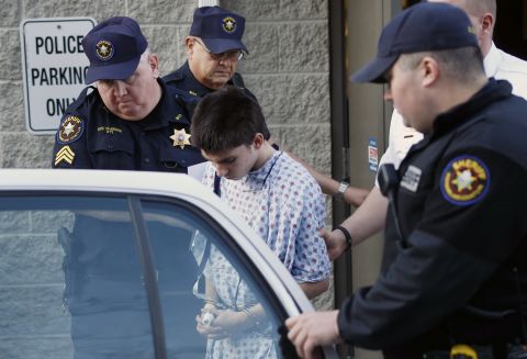 Accused attacker Alex Hribal, 16, is escorted from a district magistrate after he was arraigned as an adult on April 9. He faces four counts of attempted homicide, 21 counts of aggravated assault and one count of possession of a weapon on school grounds, according to a criminal complaint made public.