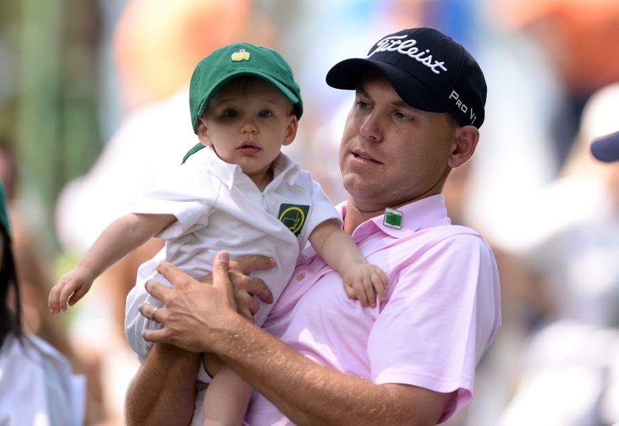 Bill Haas shows his son William around the place as the crowds gather to watch Wednesday's action.