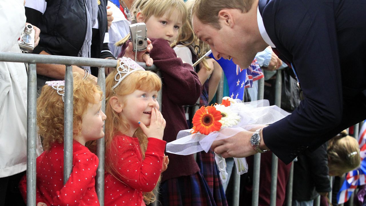 Prince William greets 3-year-old twins Lola and Milly Barnett after a wreath-laying ceremony in Blenheim.