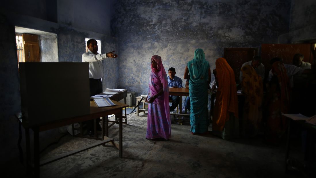 A woman is given directions by a polling station officer in Haryana on April 10.