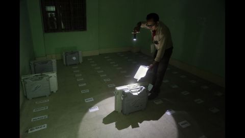 A polling officer checks the number of an electronic voting machine after it was deposited in Senapati, India, on Wednesday, April 9.