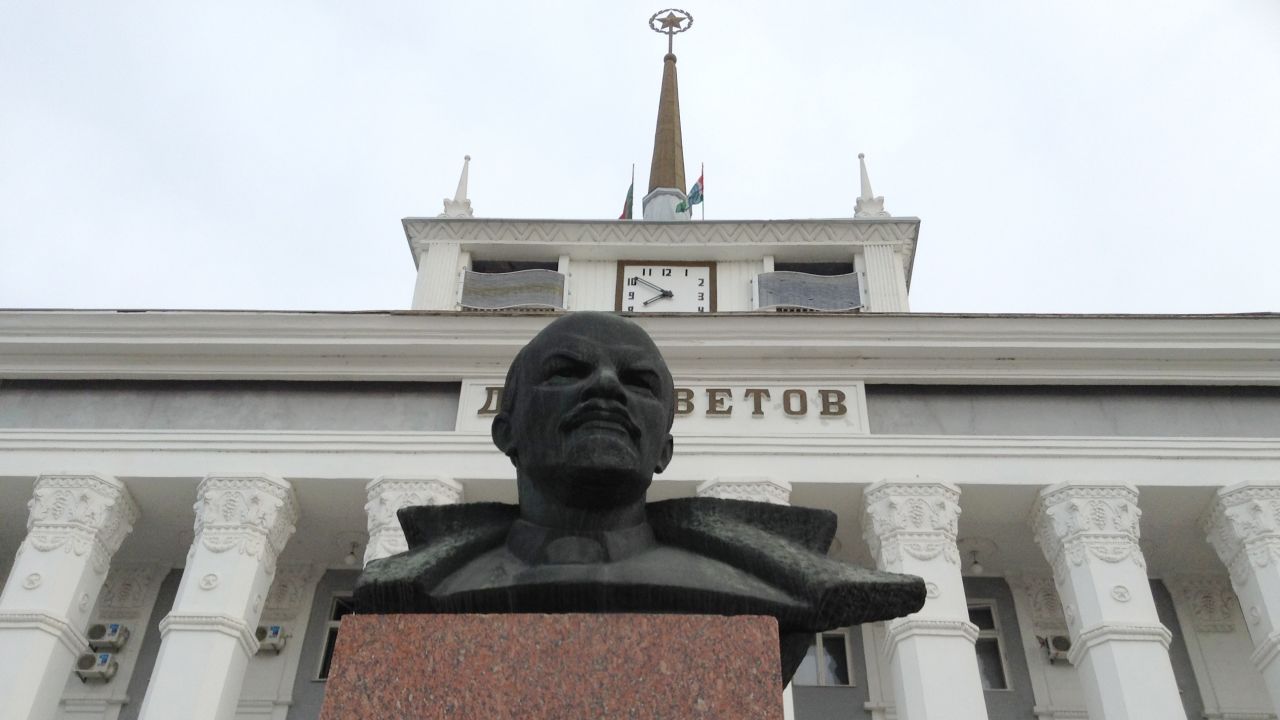 A statue of Lenin guards a building with the Soviet star still on top in Transnistria.