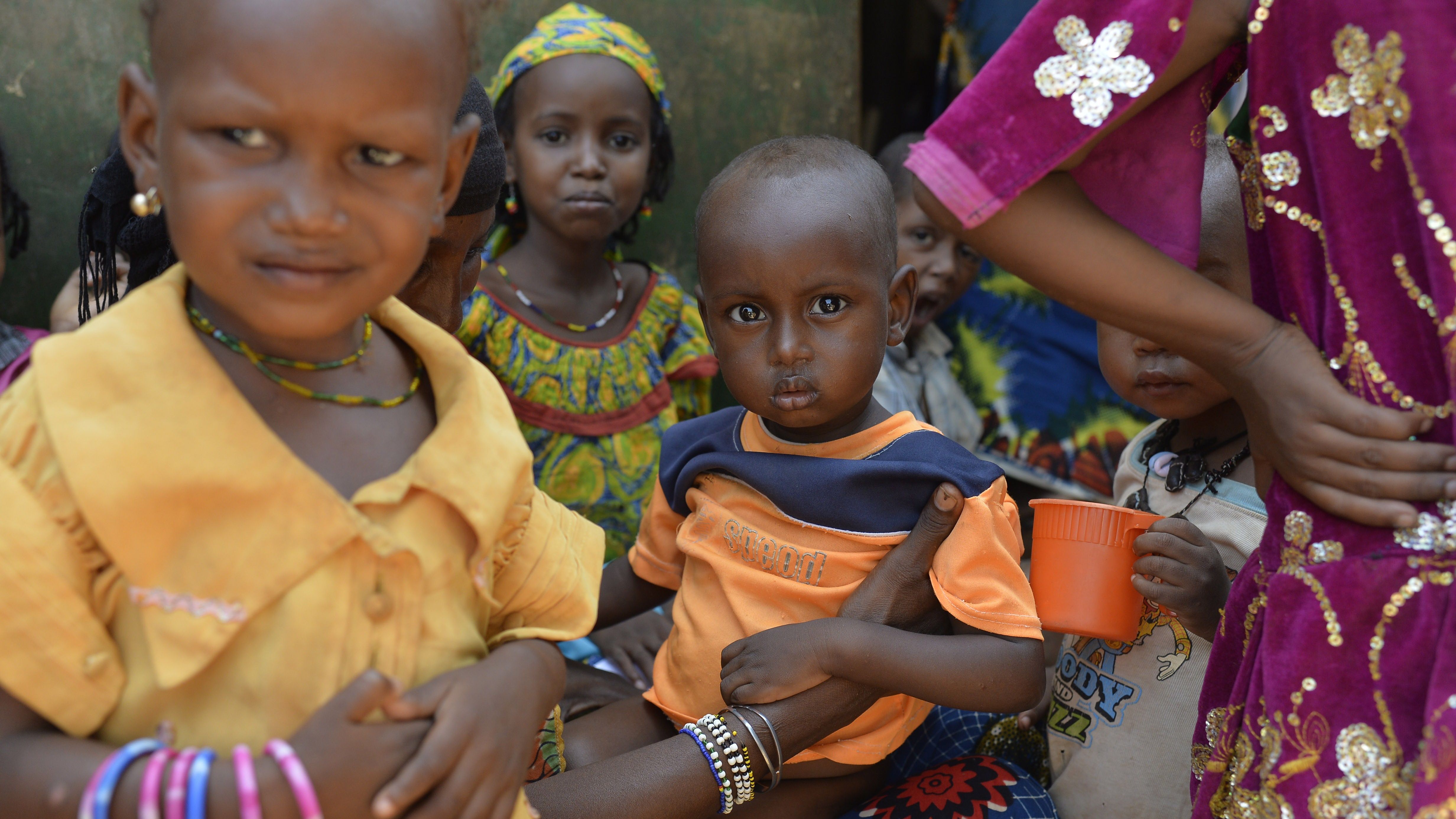Women and children wait in line in the Begoua district, northeast of Bangui, to receive aid Wednesday.