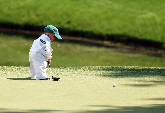Finn Stallings, the young son of professional golfer Scott Stallings, putts on a green during the Masters' Par 3 contest, held Wednesday, April 9, in Augusta, Georgia.
