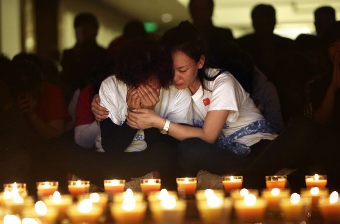 A woman cries in Beijing during a candlelight vigil held Tuesday, April 8, for those aboard Malaysia Airlines Flight 370. Authorities are <a href="http://www.cnn.com/2014/03/07/asia/gallery/malaysia-airliner/index.html">combing the southern Indian Ocean</a> in search of Flight 370, which disappeared March 8.