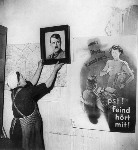 "It's not an easy profession and by and large it requires a huge amount of personal sacrifice," said Brooks. "From a historical perspective, Margaret Bourke-White was always a source of inspiration because she was such a pioneer." In this photo by Bourke-White, a woman removes a portrait of Hitler from the wall of a protestant church in Frankfurt at the end of World War Two.