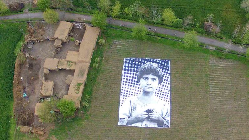 An art installation featuring a large-scale portrait of a child reportedly orphaned by a drone strike was unveiled this week in the Khyber Pakhtunkhwa area of northwest Pakistan. The project is meant to be seen from above by drone operators and aims to raise awareness about civilian casualties. The collaborative effort was inspired by French artist JR's "Inside Out" movement.