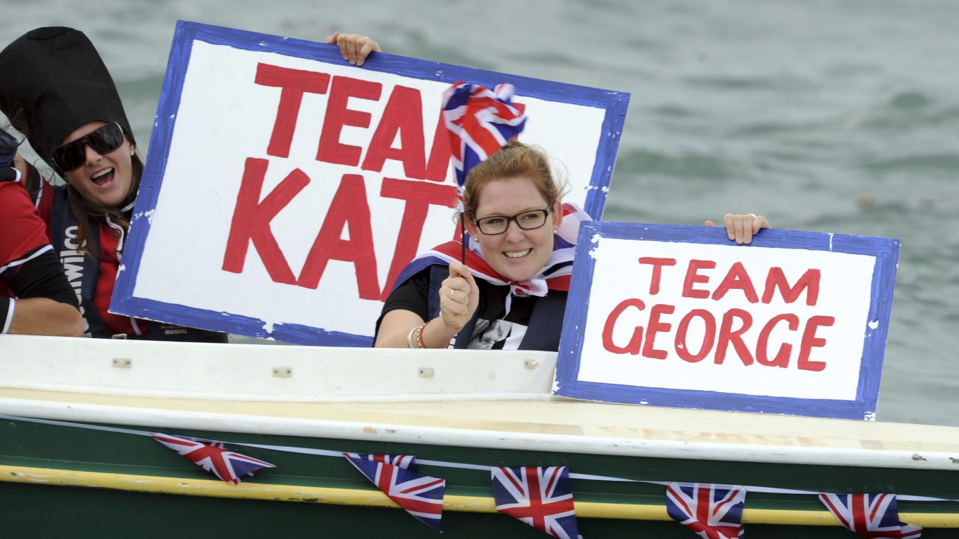 Fans of the royal family cheer them on as they race yachts in Auckland on April 11.