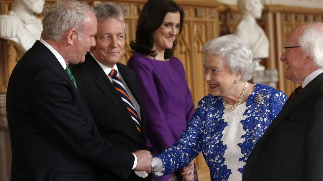 Queen Elizabeth II greets Northern Ireland Deputy First Minister Martin McGuinness, left, and First Minister Peter Robinson, second from left, and Theresa Villiers, Britain's secretary of state for Northern Ireland, during a reception at Windsor Castle on Thursday, April 10. Higgins is at the right at the Northern Ireland-themed event.