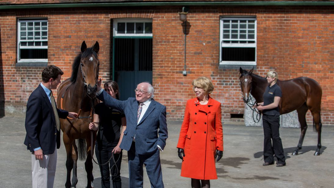 Higgins and his wife, Sabina, meet the Queen's race horses Micras and Enliven in Newbury, England, on April 10.