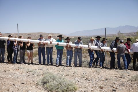People help erect a pole so that they could hang a banner April 7 in support of Bundy. One banner at the protest side stated: "Has the West been won? Or has the fight just begun!"