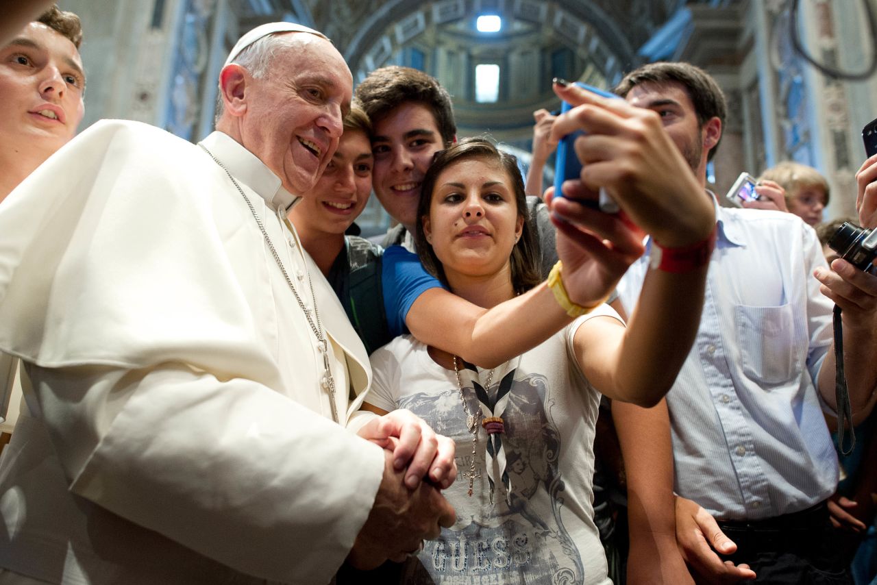Francis has his picture taken inside St. Peter's Basilica with youths who came to Rome for a pilgrimage in August 2013.