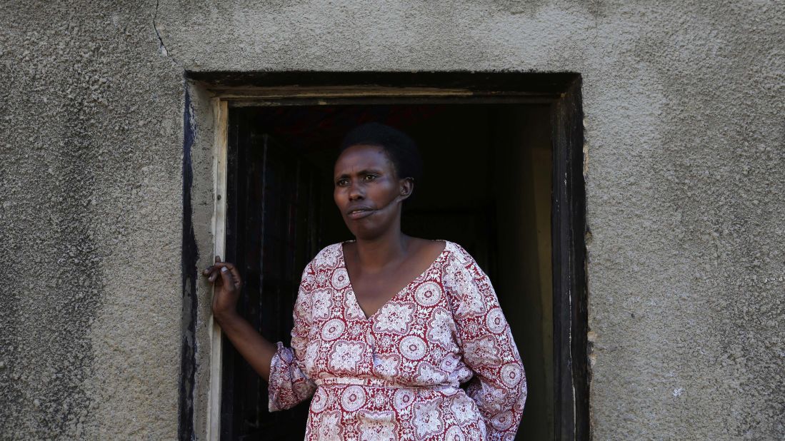 Alphonsine Mukamfizi, 42, who survived three attempts on her life and had to fake death to survive, poses at her home in Nyamata, a small town outside Kigali. The rest of her 11 family members were killed in the 1994 genocide.