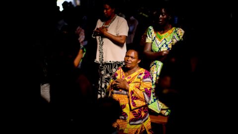 Members of the Sainte-Famille Catholic Church congregation pray during a Sunday morning service in Kigali on April 6. The church was the scene of many killings during the 1994 genocide.