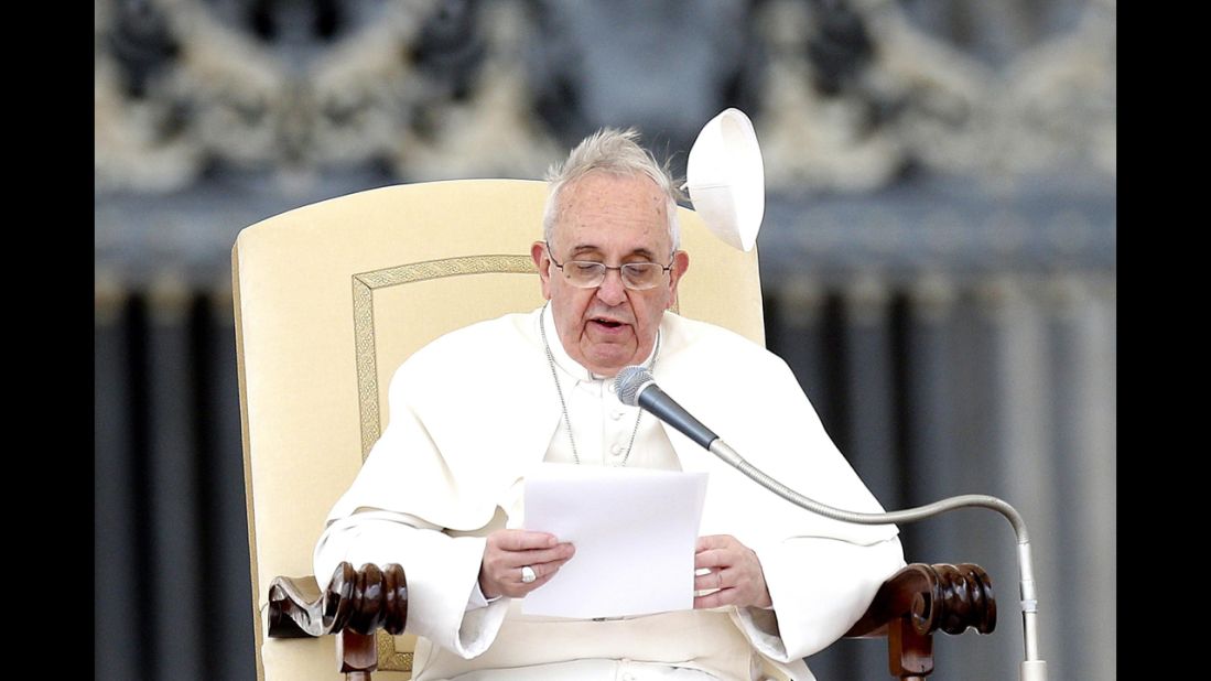 Wind blows the papal skullcap off Pope Francis' head in February 2014.