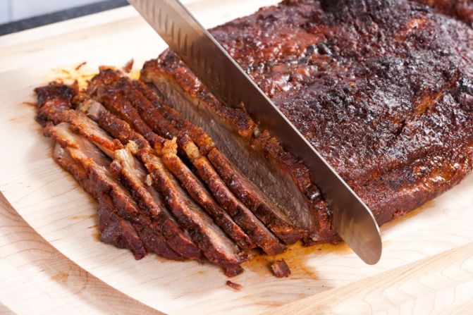 SLICE AND ENJOY: Slice the brisket across the grain and serve it with the sauce.<br />WHY? The brisket is a hardworking muscle with a heavy grain. Slicing across the grain ensures that it's tender.