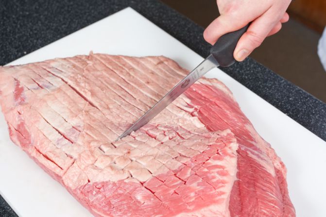 SCORE THE MEAT: Cut a crosshatch pattern in the remaining fat cap.<br />WHY? To help the fat render and let the flavors of the rub permeate the brisket.