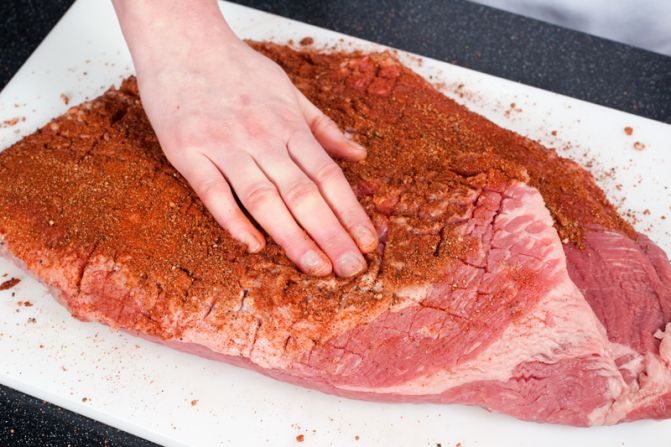 RUB AND WAIT: Massage the rub into the brisket. Then wrap the brisket in plastic, refrigerate and wait.<br />WHY? Salting the meat draws moisture to its surface. The moisture dissolves the salt, and then the meat reabsorbs it, which seasons the meat.