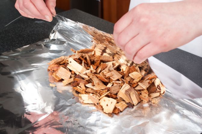 MAKE FOIL PACKET: Briefly soak the wood chips (hickory is traditional) in water, drain and wrap in foil. Cut vent holes.<br />WHY? For subtle smokiness. The wrapped chips won't burn too fast, while the vents let the smoke escape gradually and flavor the brisket.<br />