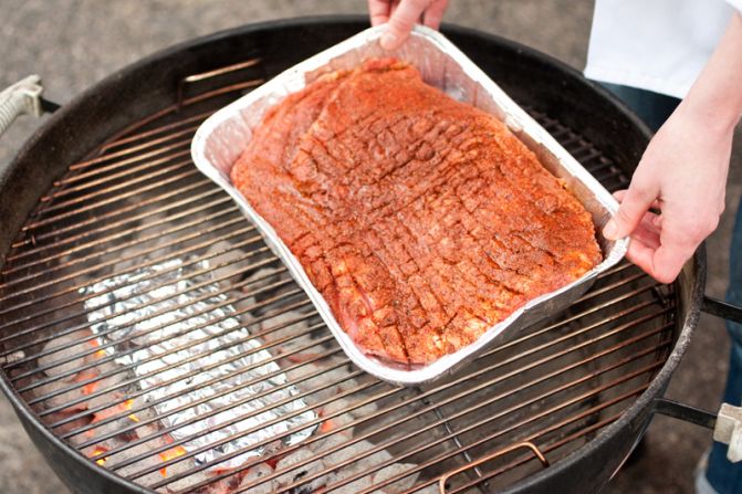 SMOKE BRISKET: Once the wood chips start to smoke, place the brisket in its pan on the grill, opposite the coals. Cook, covered, for 2 hours.<br />WHY? Smoke needs plenty of time to penetrate such a large hunk of meat. It wouldn't be barbecue without smoke.<br />