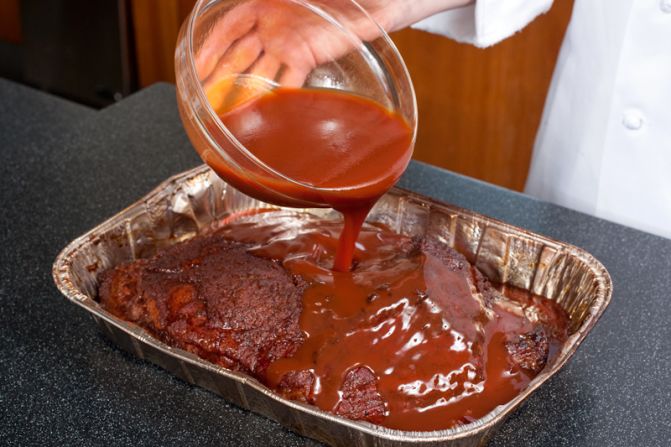 BUILD SAUCE: After removing the brisket from the grill, whisk ketchup, water, molasses and hot sauce together and pour over brisket.<br />WHY? For deep, spicy-sweet flavor. Adding the sauce before the brisket moves to the oven allows it to flavor the meat and vice versa.<br />