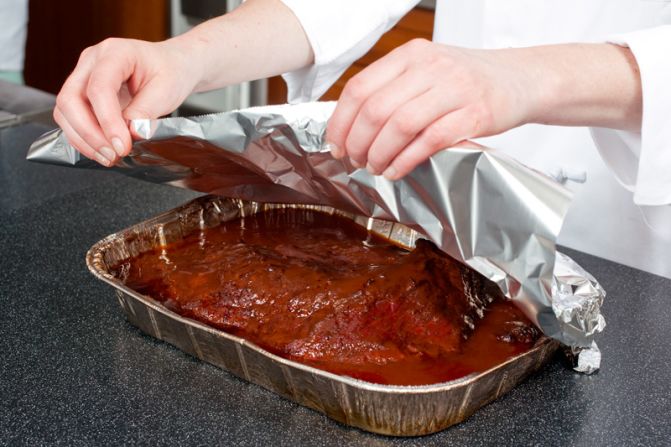 MOVE TO OVEN: Seal the disposable pan with foil and move it to a 300-degree oven.<br />WHY? It takes hours for brisket to tenderize. Instead of refueling the grill, we finish the meat in the oven, roasting it for 2 1/2 to 3 hours.<br />
