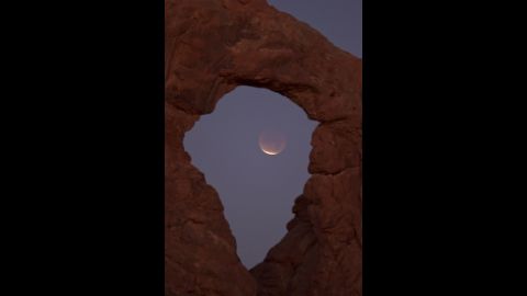 The December 2011 eclipse is seen near Moab, Utah. The moon takes on a reddish color as it passes through the Earth's shadow, which is the color of a desert sunset.
