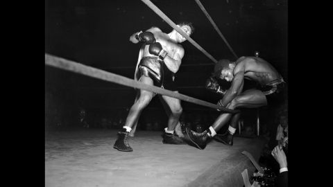 LaMotta knocks Robinson through the ropes in the eighth round of their 1943 fight. LaMotta won the decision in 10 rounds to give Robinson his first defeat in 130 fights.