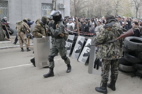 Armed pro-Russian activists carrying riot shields occupy a police station in Slovyansk on April 12.