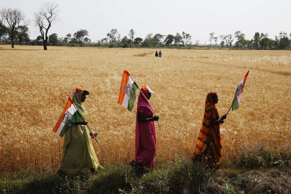 Congress Party supporters hold flags as they walk home from a Gandhi rally April 12 in the northern state of Uttar Pradesh.