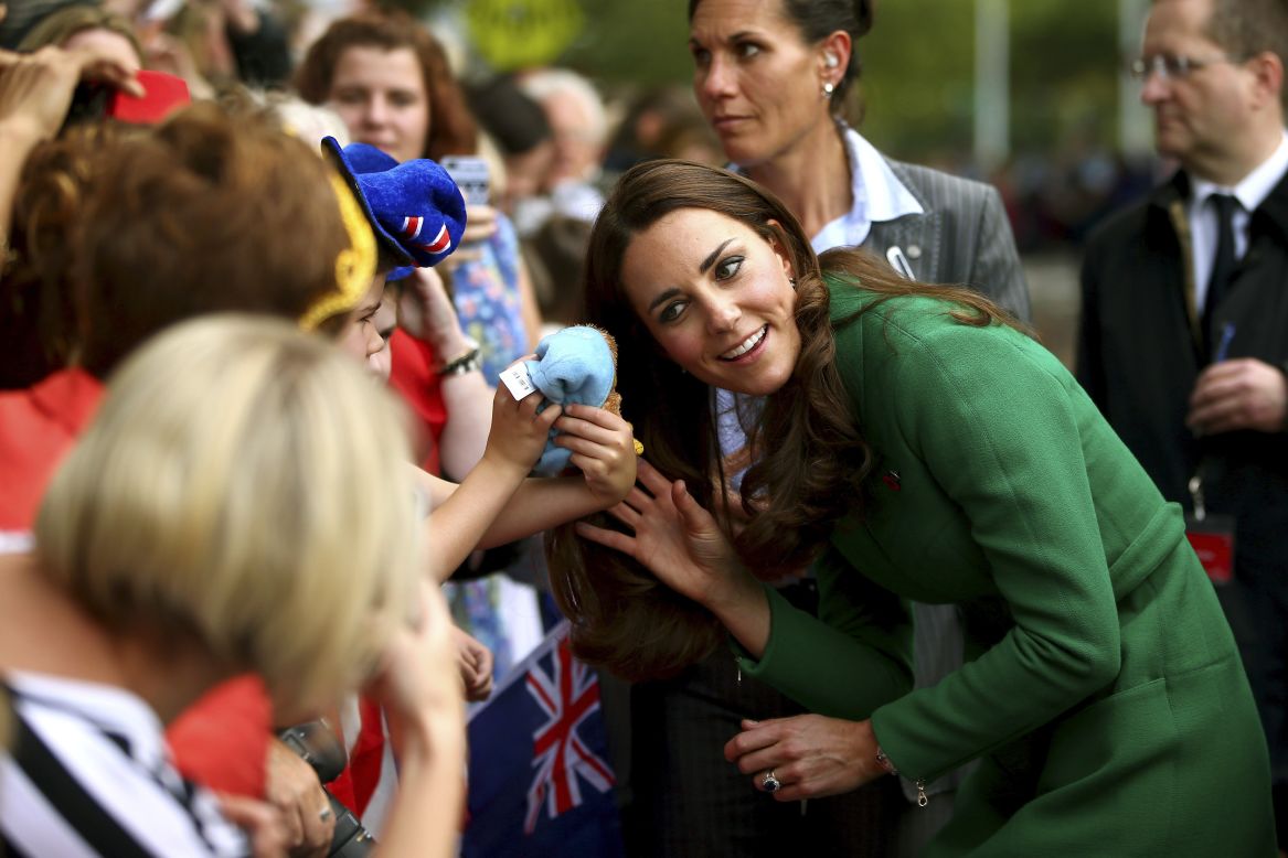 A young child shows his toy to the duchess in Cambridge, New Zealand, on April 12.