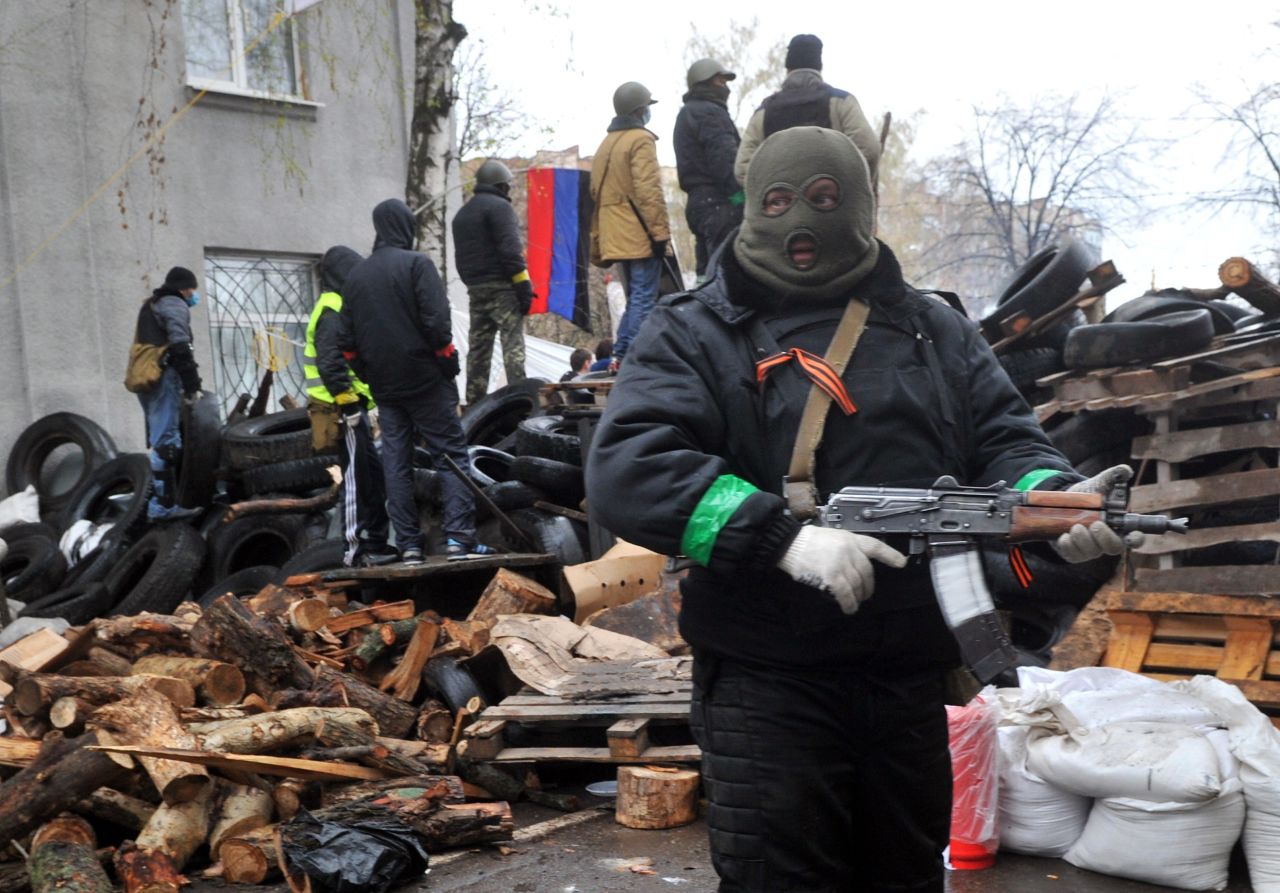 Pro-Russian protesters guard a barricade in Slovyansk on April 13 outside a regional police building seized by armed separatists the day before.