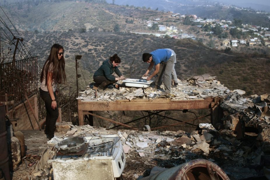 Family members rummage through the ruins of their home on April 13.