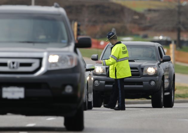 A Kansas state trooper controls traffic at the entrance of the Jewish Community Center on April 13.