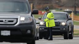 A Kansas State Trooper controls traffic at the entrance of the Jewish Community Center after the shooting.