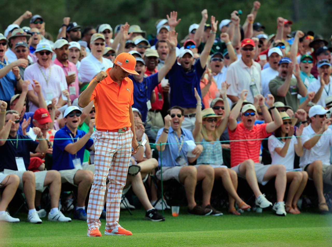 Resplendent in orange, Rickie Fowler milks the applause of the crowd after holing a monster putt on the ninth in the final round.