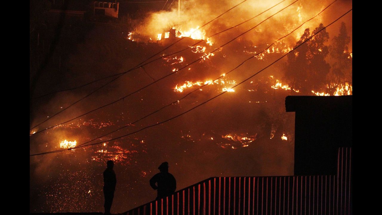 People watch the flames destroy homes in Valparaiso.