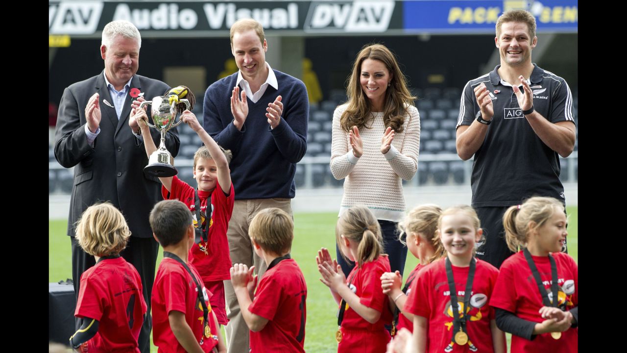 New Zealand Rugby CEO Steve Tew, left, the royal couple and All Blacks captain Richie McCaw congratulate the winners of the the young players' rugby tournament at Forsyth Barr Stadium in Dunedin on April 13.