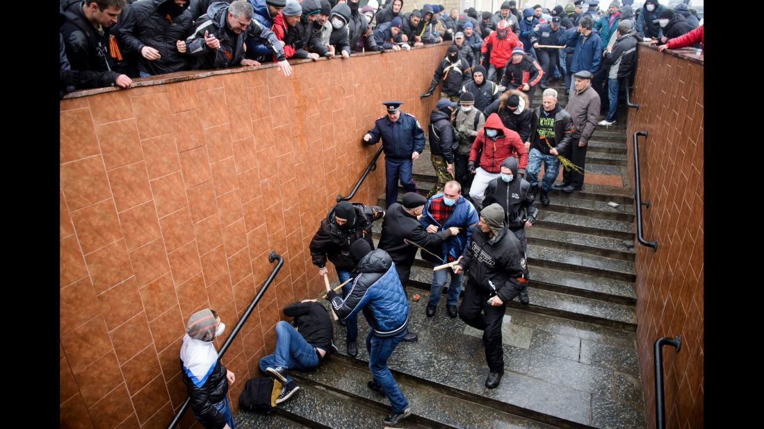 Pro-Russian supporters beat a pro-Ukrainian activist during a rally in Kharkiv on Sunday, April 13.