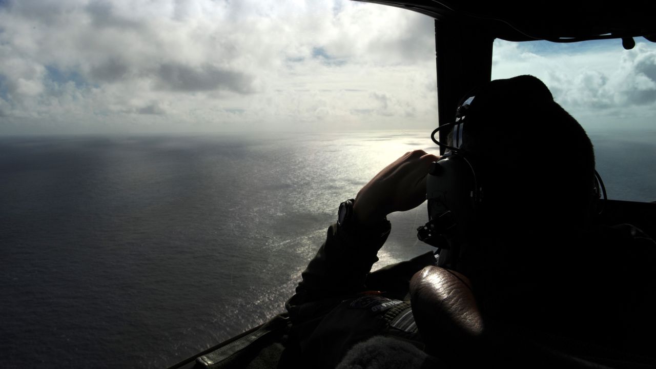 A member of the Royal New Zealand Air Force looks out of a window while searching for debris off the coast of western Australia on April 13, 2014.