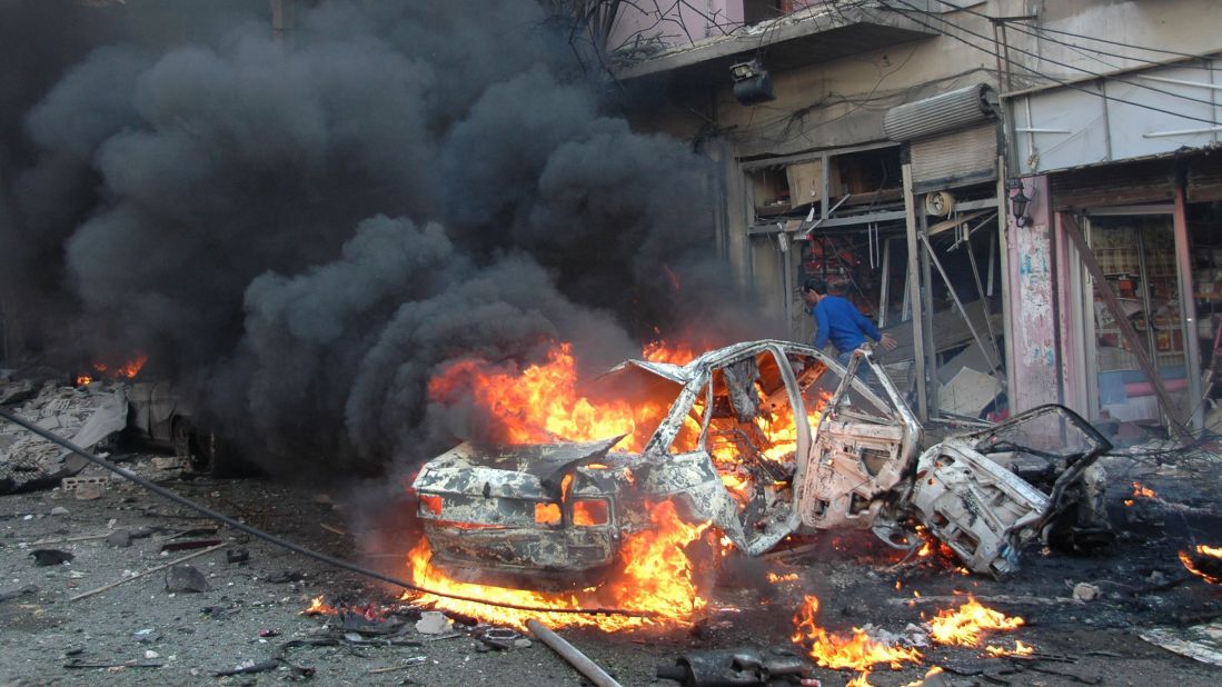 Flames engulf a vehicle following a car bomb Wednesday, April 9, in the Karm al-Loz neighborhood of Homs.